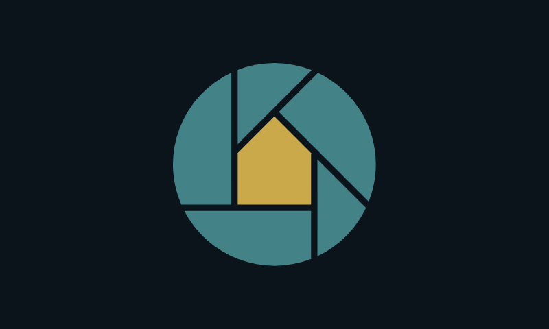 The Reelhouse app icon: a teal lens iris with a lit mustard house at its centre.